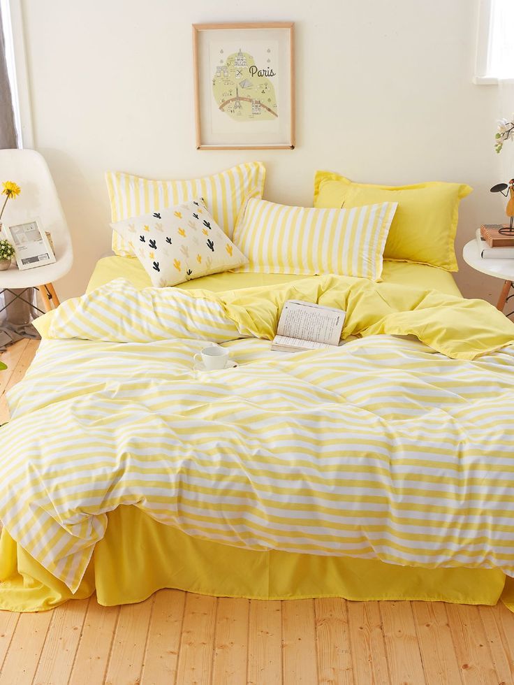 a bed with yellow and white striped sheets