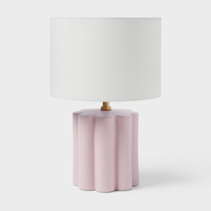 a pink table lamp with a white shade