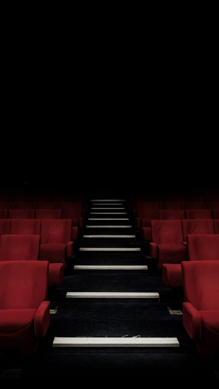 rows of red seats in an empty theater