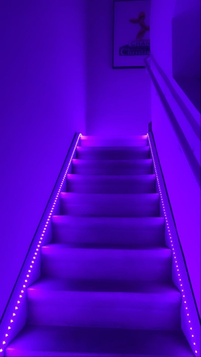 the stairs are lit up with purple lights and there is no image on it to describe