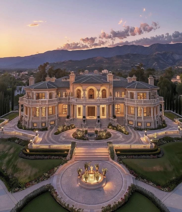 an aerial view of a large mansion at dusk