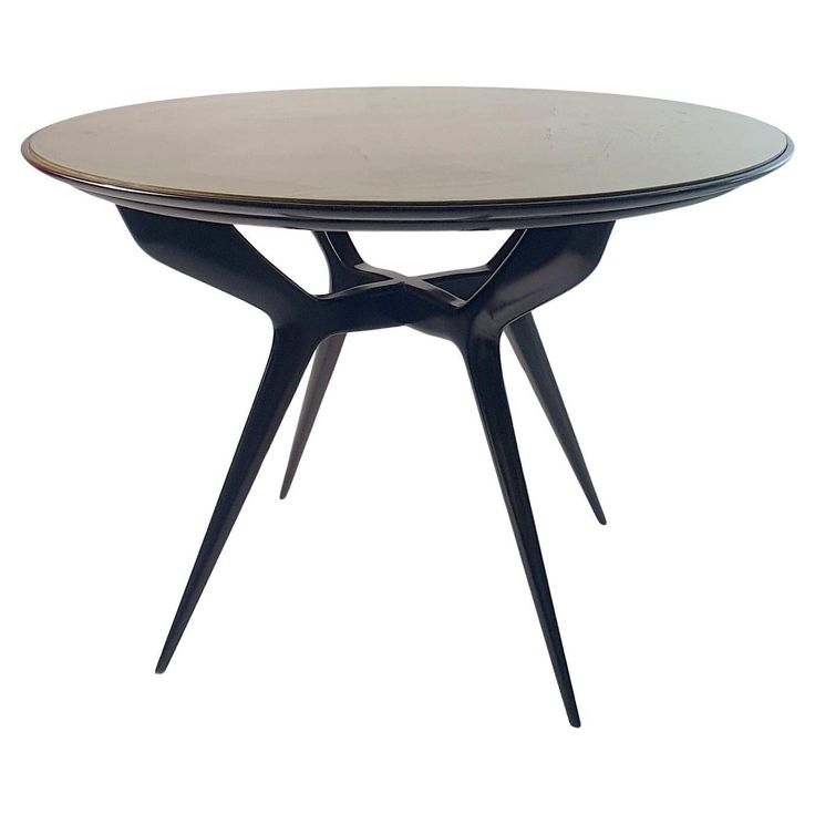 an oval table with black legs and a glass top, on a white background in the shape of a cross