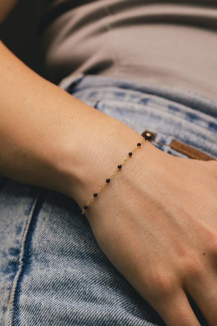 From our Color Romance Collection, this black enamel beaded piatto chain will add a pop of color to any outfit. Crafted in 14K gold, this 1 inch adjustable chain secures with a spring ring. NECKLACE DETAILS: Length: 7.5 Inches Millimeter: 1.7 Gauge: 030 Average Weight (g): 0.73 Closure: 5.0m Spring Ring Available in 14K Yellow Gold ***These necklaces have a 4 week lead time. If you need your necklace sooner than that, please contact us prior to ordering to verify if that's possible.*** | Black Enamel Bead Piatto Chain Bracelet In 14K Yellow Gold Ring - by Staghead Designs - Unisex Minimal Bangles Jewelry, Handmade Black Jewelry For Everyday, Black Handmade Jewelry For Everyday, Handmade Black Everyday Jewelry, Elegant Black Beaded Bracelet With Adjustable Chain, Minimalist Onyx Round Bead Jewelry, Minimalist Onyx Bead Jewelry, Trendy Handmade Black Jewelry, Trendy Black Handmade Jewelry