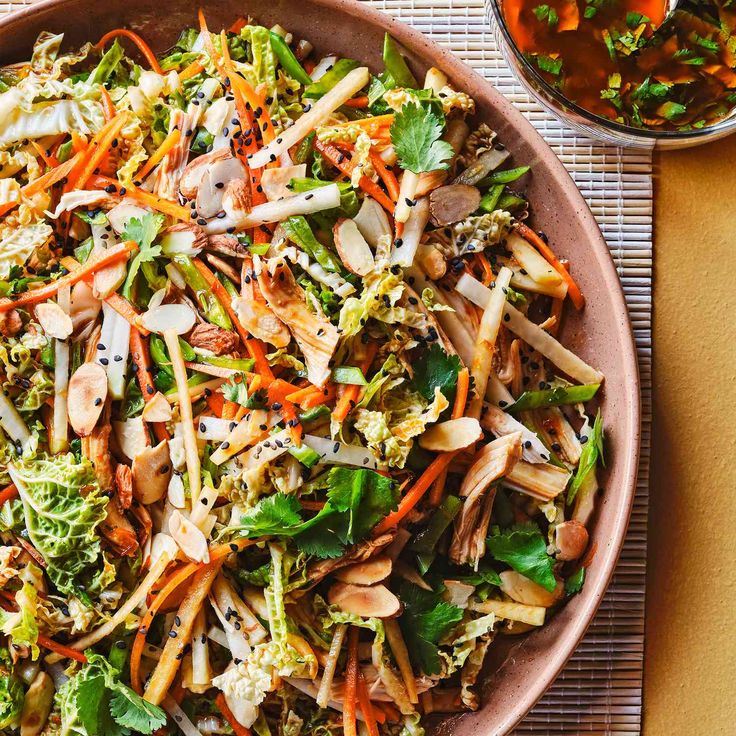 a large bowl filled with lots of different types of food on top of a table