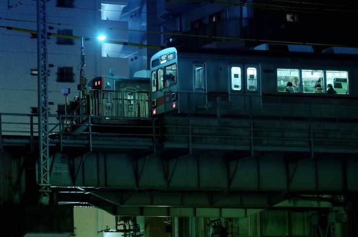 a train traveling over a bridge at night