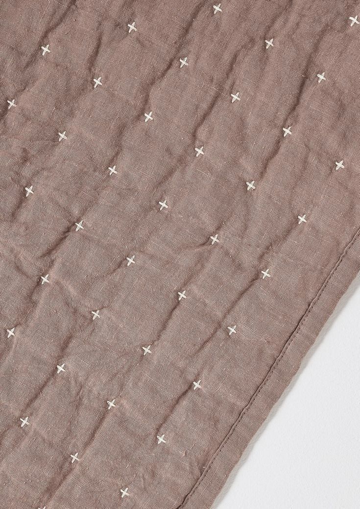 an unmade blanket with white stars on it