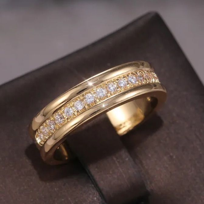 a yellow gold ring with diamonds on it