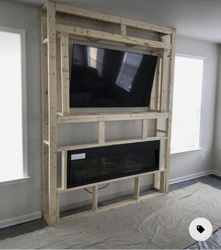 a tv mounted to the side of a wall in a living room with no furniture