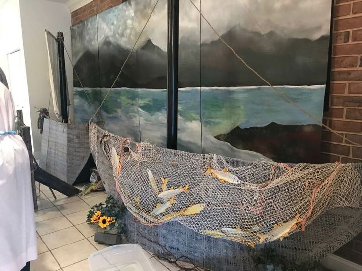 there is a painting on the wall behind a hammock that has been tied up