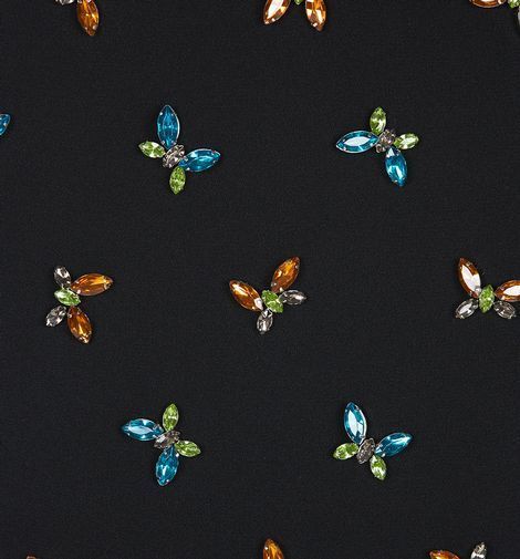 many different colored jewels on a black surface