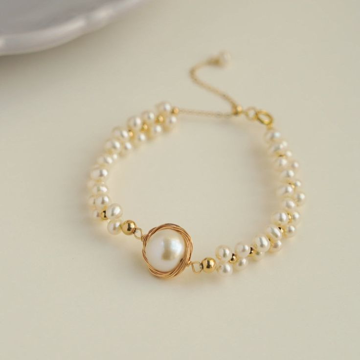 Discover the elegance and beauty of our Coco Kim Classic Wrapped Series Stargazer Pearl Bracelet. Handcrafted with care and attention to detail, this stunning bracelet features a classic wrapped design and luminous pearls that will add a touch of sophistication to any outfit. Elevate your style and make a statement with this must-have accessory. Metal: 14k Gold Filled Pearl: Freshwater Pearls Main Pearl Diameter: 13-15mm (including metal parts) Chain Length: 150mm + 50mm adjustable chain Elegant Rose Gold Pearl Bracelet With Round Beads, Adjustable Pearl Bracelet With Pearl Pendant For Wedding, Adjustable Pearl Bracelet With Pearl Pendant, Adjustable Pearl Bracelets With Pearl Pendant, Adjustable Bracelet With Pearl Pendant, Elegant Adjustable Bracelet With Pearl Pendant, Elegant Adjustable Bracelets With Pearl Pendant, Elegant Pearl Pendant Bracelet, Formal Rose Gold Pearl Bracelet