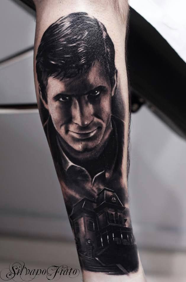 a man's arm with a black and grey portrait on it