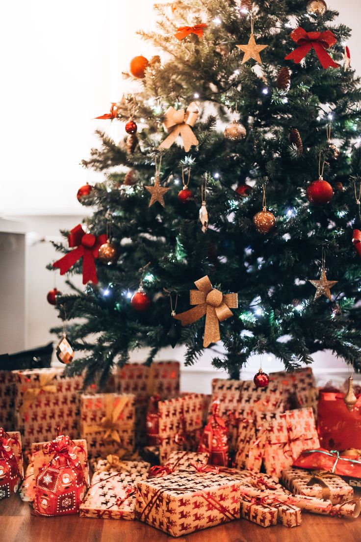 a christmas tree with presents under it