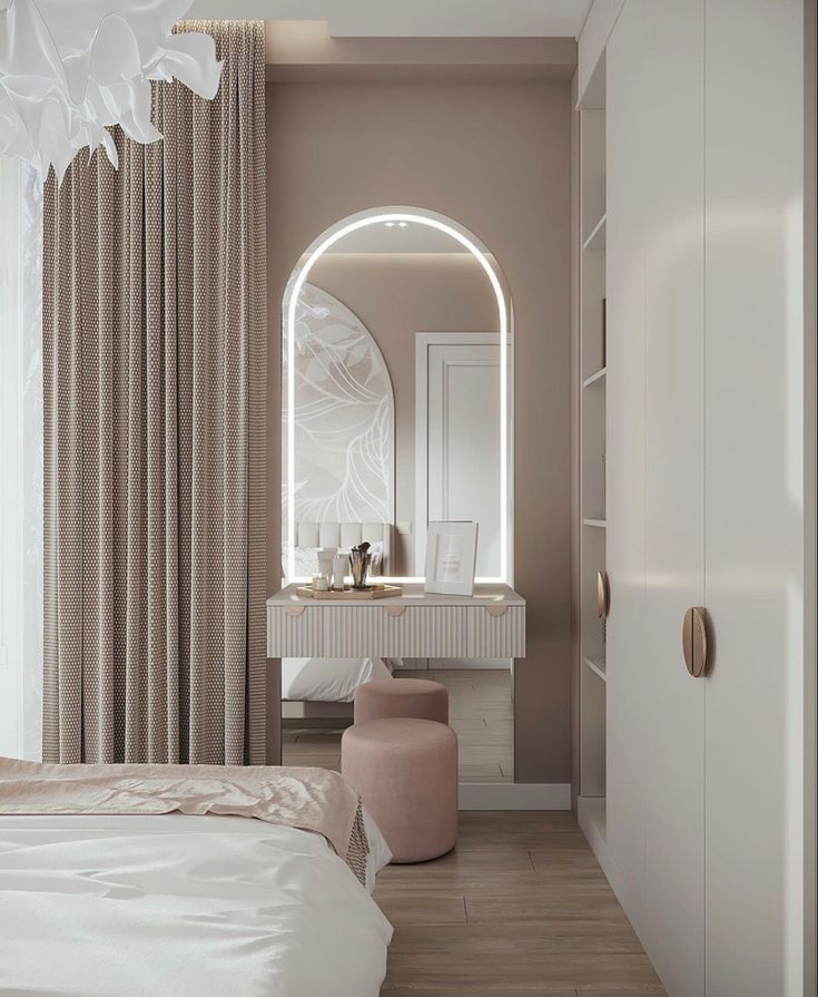 a white bed sitting under a large mirror in a bedroom next to a tall window