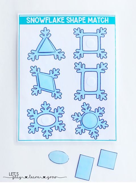 the snowflake shape match is displayed on a white surface with cut outs and glue