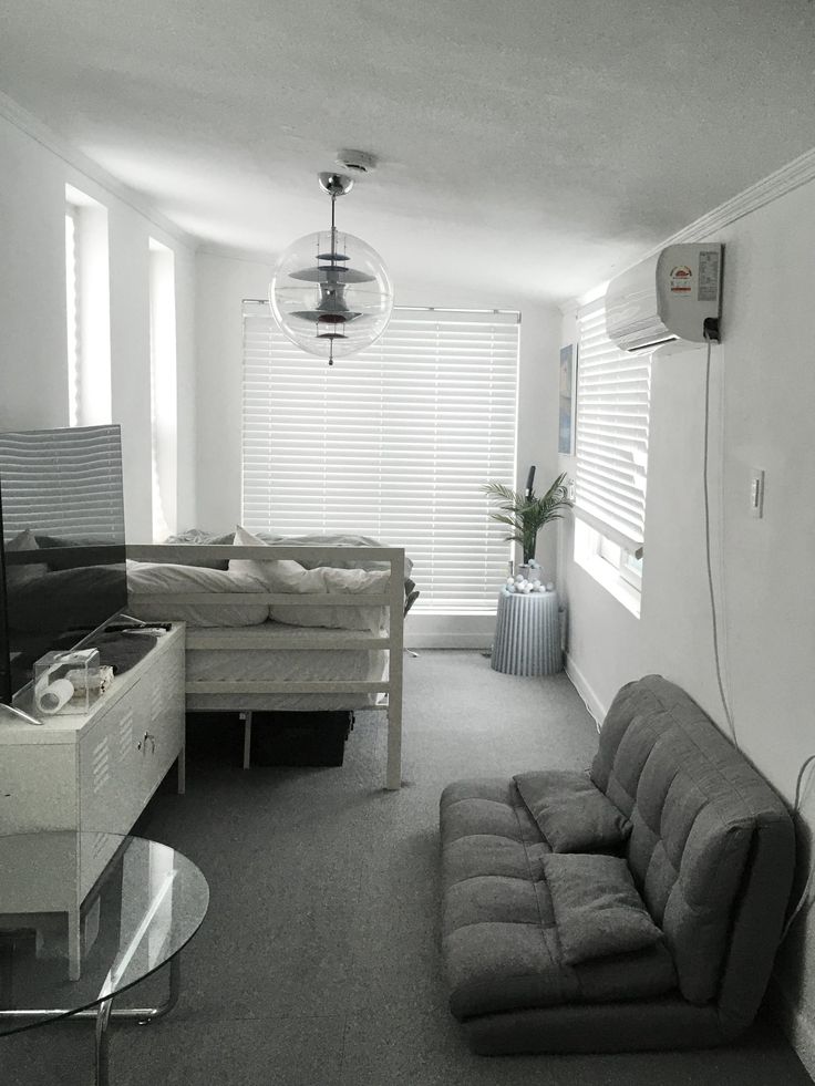 a living room filled with furniture and a flat screen tv mounted to the side of a wall