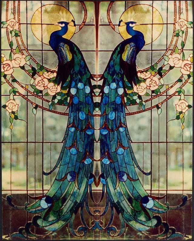 a stained glass window with two peacocks on it's wings and the moon in the background