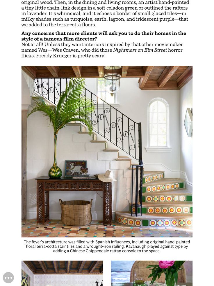 the inside of a house with stairs and potted plants