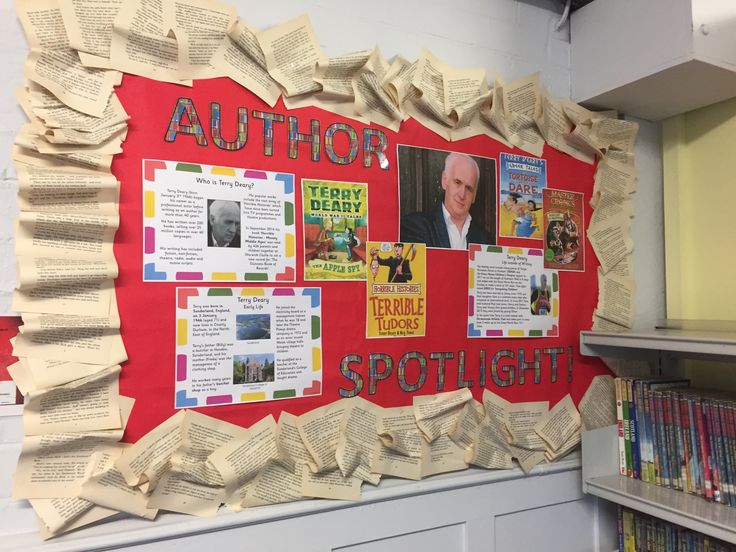 the bulletin board is covered in newspaper strips