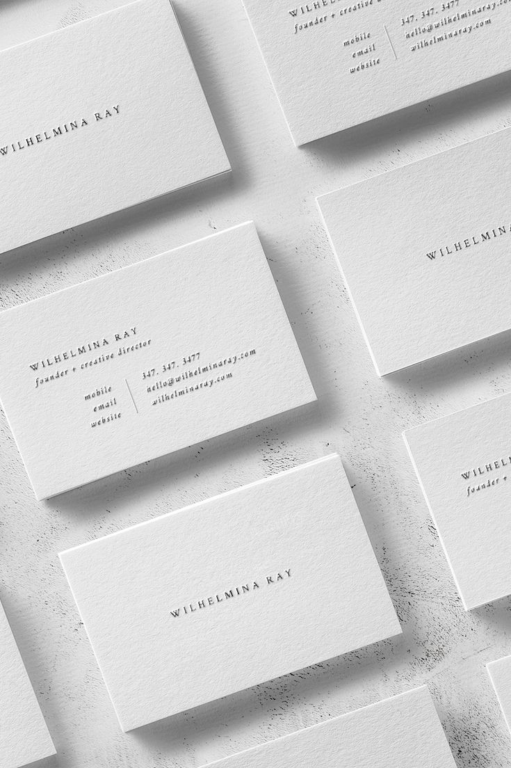 many business cards are laid out on top of each other, all in white paper