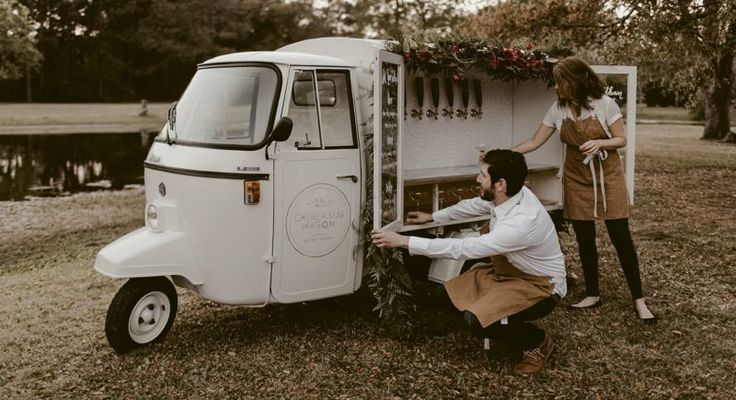 a man and woman standing next to an ice cream truck