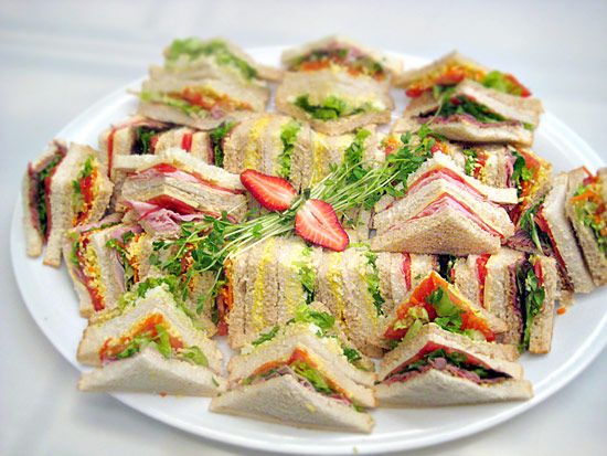 a white plate topped with cut in half sandwiches