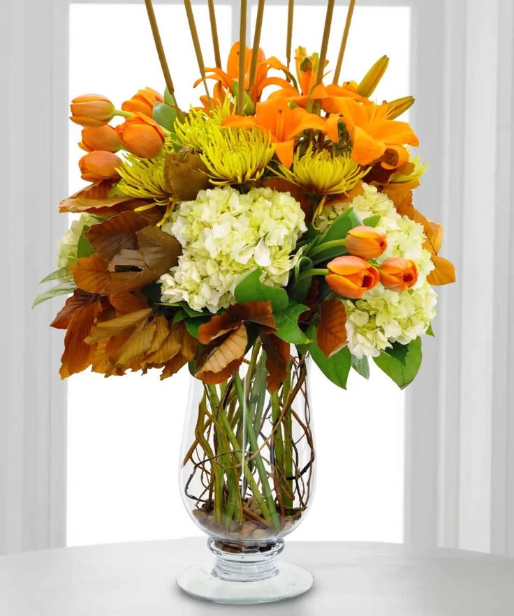 a vase filled with orange and white flowers