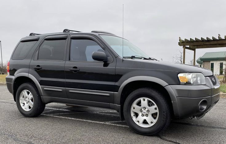 a black suv parked in a parking lot