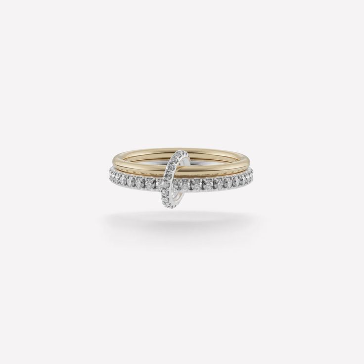 The Astrid SG Gris is comprised of two linked bands in mixed metals of 18k yellow gold and .925 sterling silver, further enhanced by pavé-set gray diamond accents for a dazzling display. Lightweight and comfortable, the Astrid SG Gris is the perfect subtle statement of luxury. Each Astrid SG Gris is individually handmade in downtown Los Angeles. Bands: 18k yellow gold, .925 sterling silver 1.7mm gauge 18k yellow gold band 2.3mm gauge .925 sterling silver band Stones: Gray diamonds (approx. 0.83 Spinelli Kilcollin Wedding Band, Linked Rings, Mixed Metal Ring, Mixed Metal Rings, Gray Diamond, Stone Ornaments, Luxury Jewelry Brands, Luxury Rings, Grey Diamond