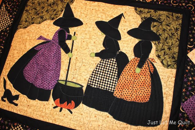 three witches are standing next to each other on a quilted wall hanging or table runner