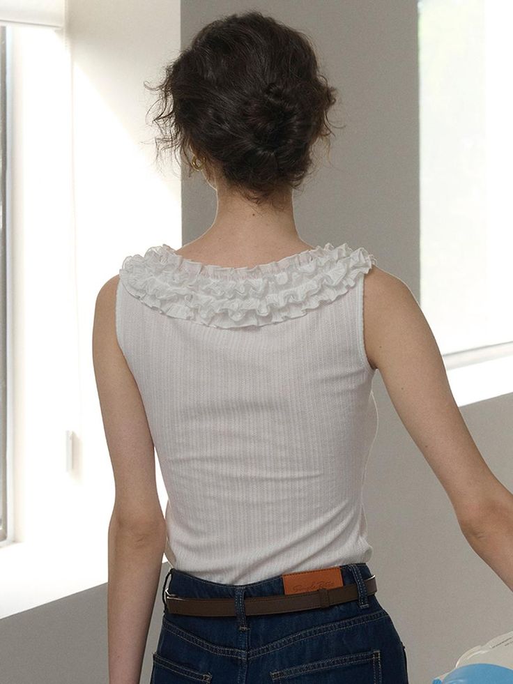 This product, the Lace Neck Sleeveless Top, combines classic and contemporary elements beautifully. It features a sophisticated lace-trimmed neckline, adding a delicate and feminine touch to the design. The fitted silhouette complements the wearer's figure, making it an excellent choice for both casual and more formal settings. - This Lace Neck Sleeveless Top is highlighted by an ornate lace collar that frames the face elegantly.- It is constructed from a soft, ribbed fabric that ensures a comfortable fit while providing a subtle texture.- The sleeveless design makes this top a perfect choice for warm weather, allowing for ease of movement and layering.- A slight stretch in the fabric allows it to conform gracefully to different body types, enhancing comfort and wearability. Elegant Sleeveless Tank Top For Daywear, Classic Fitted Sleeveless Camisole, Feminine Fitted Tank Top With Lace Trim, Fitted Lace Tank Top For Daywear, Feminine Lace Trim Sleeveless Blouse Tank Top, Chic Sleeveless Lace Top With Lace Trim, Chic Sleeveless Lace Trim Top, Elegant Summer Tank Top With Lace Trim, Elegant Sleeveless Lace Blouse For Summer