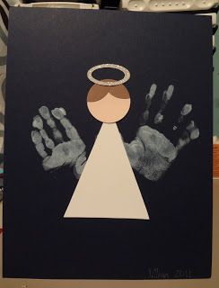 an angel handprint on a black card with white hands and a halo above it