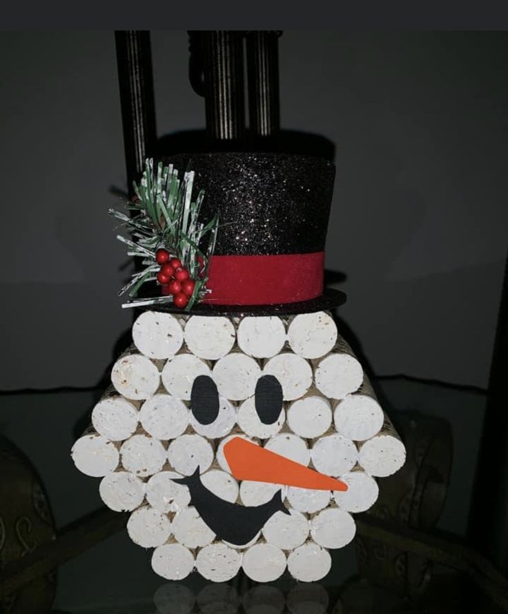 a paper snowman made out of wine corks