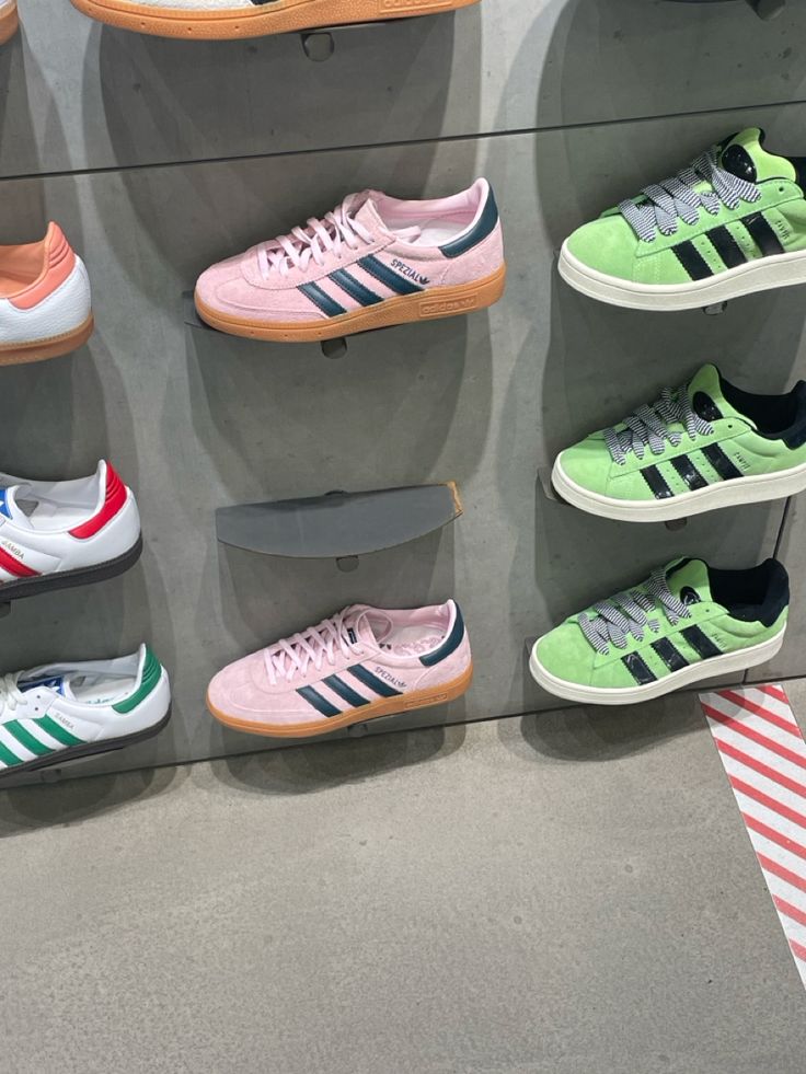 several pairs of adidas shoes are on display