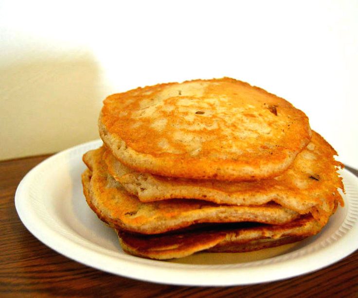 a stack of pancakes sitting on top of a white plate