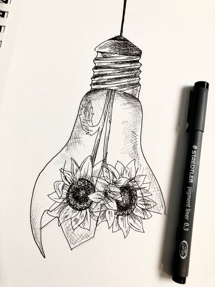 a drawing of a light bulb with sunflowers on it and a pen next to it