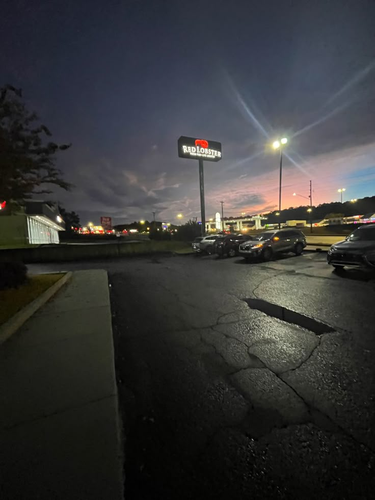 a parking lot with cars parked in it at night