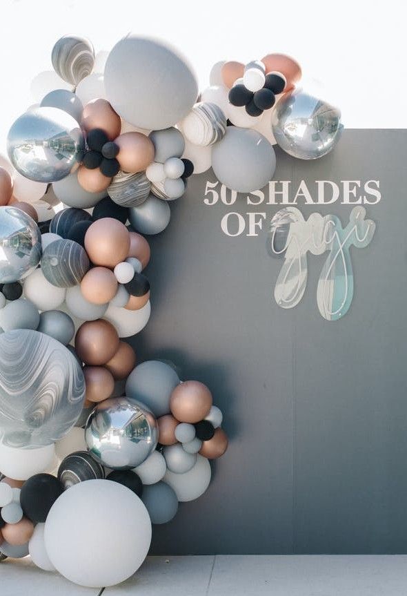 balloons are arranged in the shape of an e for fifty shades of grey and white