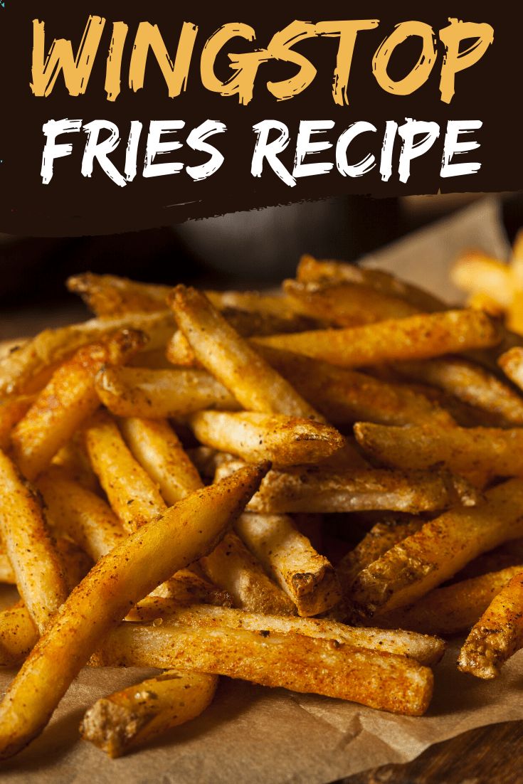 a pile of french fries sitting on top of a wooden cutting board with the words wingstop fries recipe