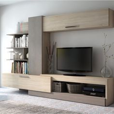 an entertainment center with bookshelves and a flat screen tv mounted on the wall