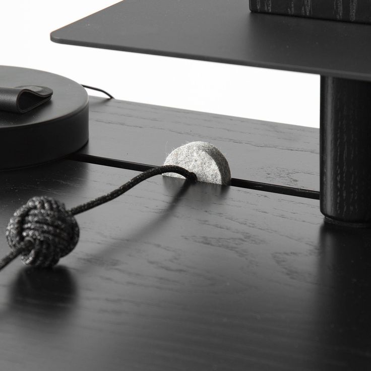 a black and white photo of a knot on a table next to a computer monitor