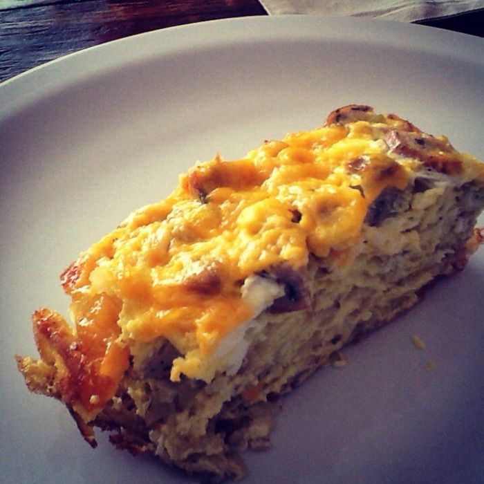 a close up of a plate of food with broccoli and cheese on it