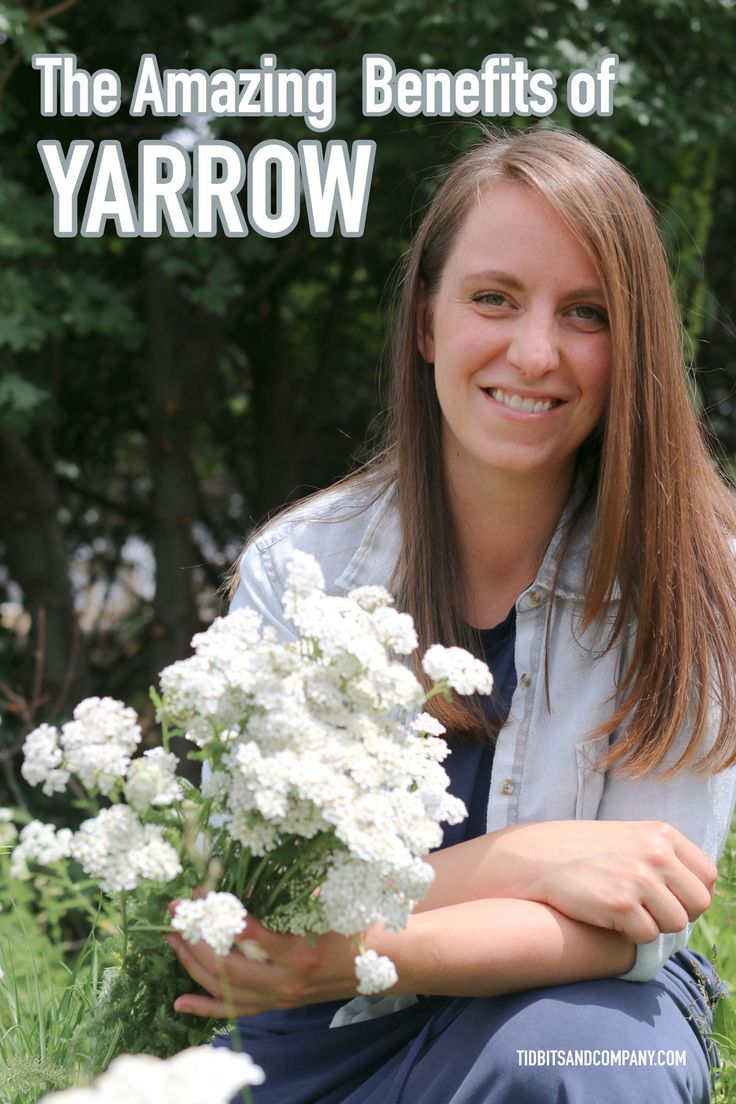 a woman sitting on the grass with flowers in front of her and text that reads, the amazing benefits of yarrow