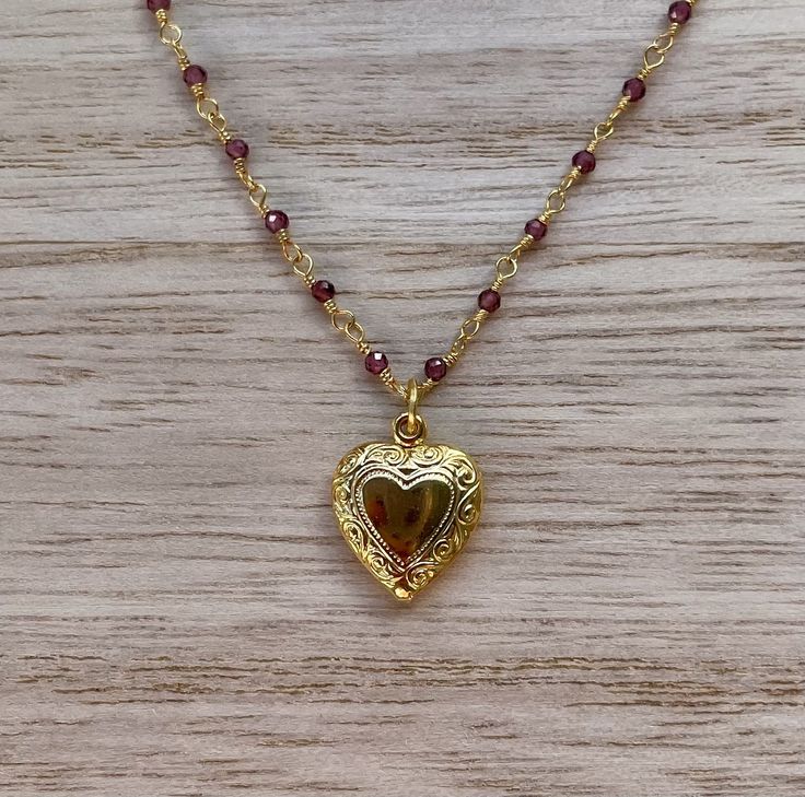 This dainty necklace is handcrafted using a 2mm authentic garnet wire-wrapped chain and a 11mm heart pendant. *Please note that the pendant does not have a garnet stone.* The chain and pendant are 24k gold plated.  This necklace is hypoallergenic. (Cadium free, lead free, and nickel safe) Garnet is an energizing stone that promotes passion and love.  The necklace comes in a ribbon-wrapped box, ready to be gifted. If you would like to leave a note for the recipient, you can do so during checkout. Jewelry Making Gold, 90s Inspired Jewelry, Gold Garnet Jewelry, Vintage Necklace Gold, Red And Gold Jewelry Aesthetic, Hispanic Necklace, Vintage Aesthetic Jewelry, Good Necklace Jewellery, Gold Necklace With Heart Pendant