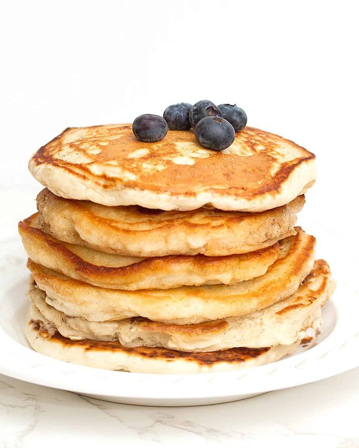 a stack of pancakes with blueberries on top