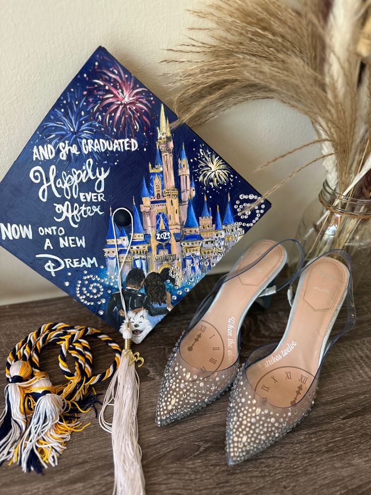 a graduation cap, tassel and shoes are on a table with a disney world hat