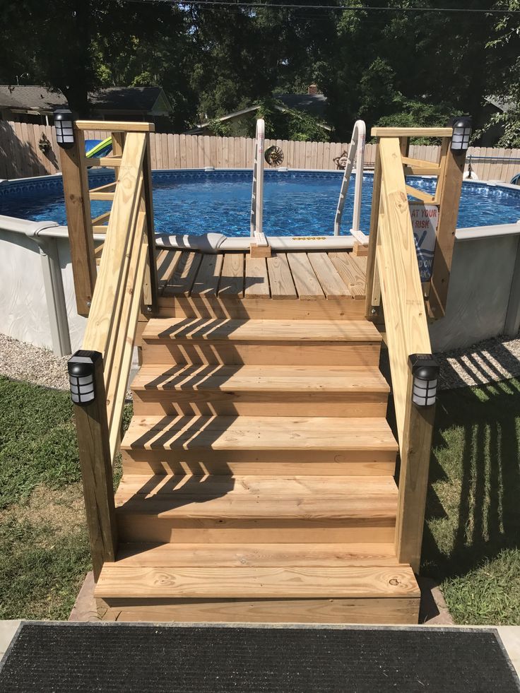 a wooden staircase leading up to a swimming pool