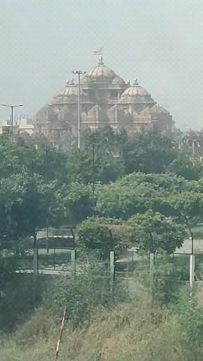 an old building is in the distance behind trees