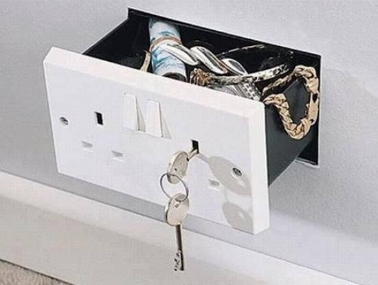 an electrical outlet with two keys in it and a key chain hanging from the wall