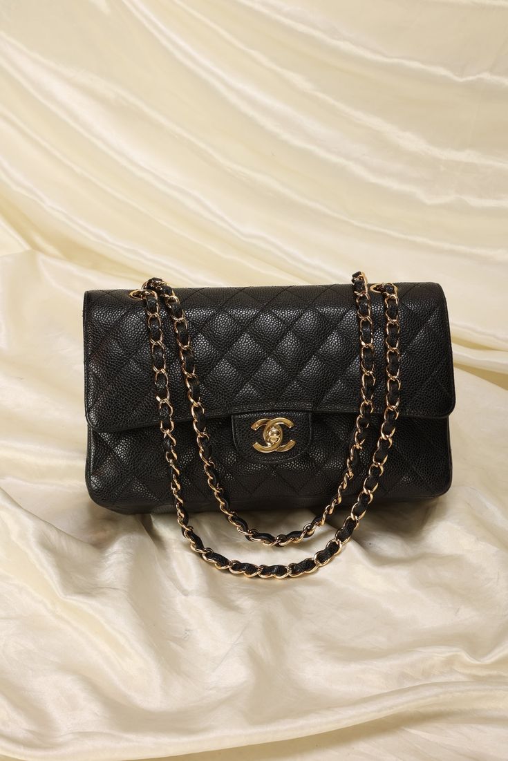 CONDITION: VERY GOOD VINTAGE .??¨ Twin with me! My favorite style by Chanel, the Caviar Classic Double Flap! This gold and caviar combo in particular is extremely difficult to come by as not only the size the most popular, the 24kt gold plated hardware is highly coveted! In this combo and condition, bag goes for between $9k-$10k on the resale market! Extremely versatile piece can be as a long or short shoulder bag.??¨ Crafted in 2006-2008. Please note: Extremely light??¨rubbing on corners, but not noticeable! Clean interior. Beautiful vintage condition.??¨ In order to meet the current demand and given the??¨nature of sourcing inventory, all sales are final. Please be sure to review all pictures and ask any questions prior to making a purchase! To prevent any form of fraud, I??¨keep video r Black And Gold Chanel Bag, Classic Black Bags, Chanel Caviar Bag, Chanel Double Flap Bag, Black Chanel Bag, Chanel Bag Outfit, Classic Channel, Chanel Double Flap, Chanel Classic Flap Bag